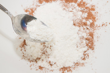 The flour is mixed with dry cocoa powder in a mixing bowl
