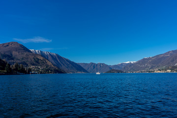 Italy, Bellagio, Lake Como, a large body of water with a mountain in the background