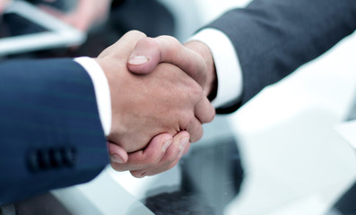 Two confident business man shaking hands