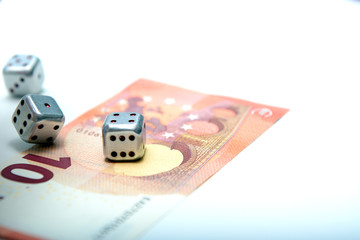 metal dice roll on a ten euro bill.  Successful bet in the game