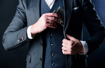 Flat metal bottle for alcohol. Man bearded hipster wear elegant suit hold metal flask for alcohol. Guy hide metal flask into pocket. Alcohol drink concept. Have alcohol drink with you. Always with me