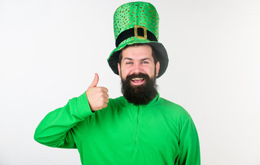 Showing his thumbs up. Happy irish man with beard wearing green. Hipster in leprechaun hat and...