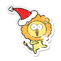 happy distressed sticker cartoon of a lion wearing santa hat