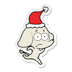 sticker cartoon of a unsure elephant running away wearing santa hat