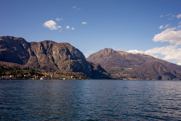 Fototapeta na wymiar Italy, Lecco, Lake Como, a large body of water with a mountain in the background