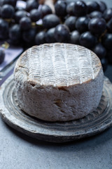 Whole round mature French Tomme cheese close up