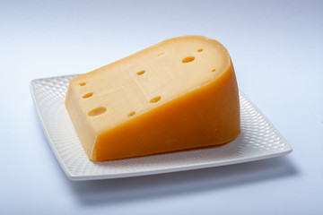 One piece of traditional Dutch old hard cheese made from cow milk