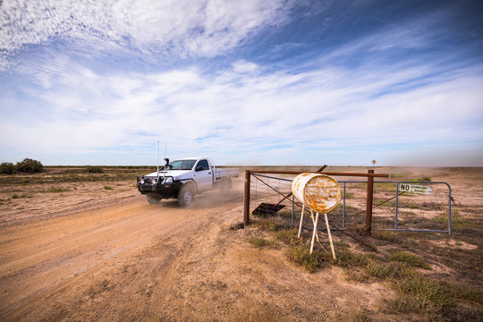 A farmer drives out of a large farm property in outback New South Wales.