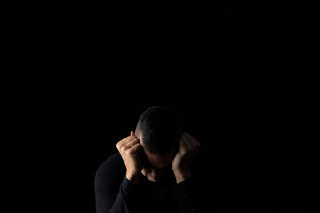 desperate man with his hands in his head.