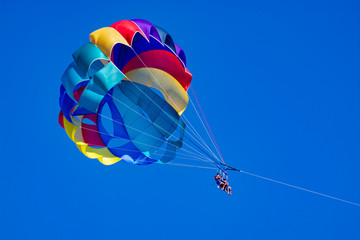 Sea and beach sport for tourists, parasailing in blue sky