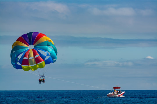 Sea and beach sport for tourists, parasailing in blue sky
