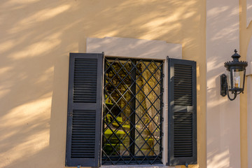 Italy, Lecco, Lake Como, a close up of a window on yellow building