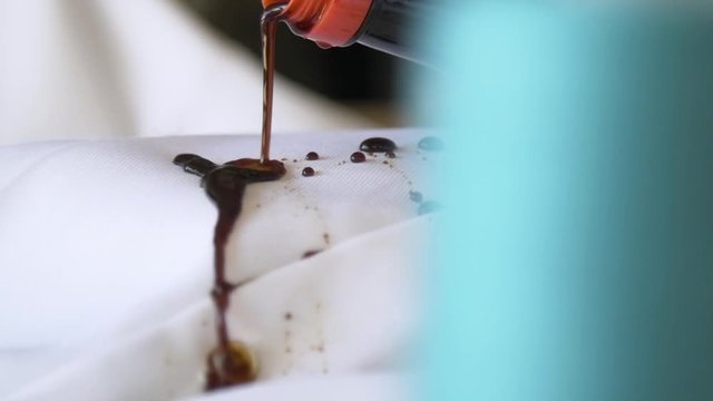 Pouring soy sauce on a moisture wicking dress shirt.