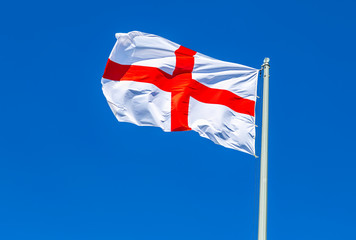 Flag of England waving in the wind against the sky