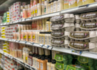 blurred background with supermarket shelves of dairy products