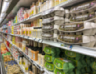 blurred background with supermarket shelves of dairy products