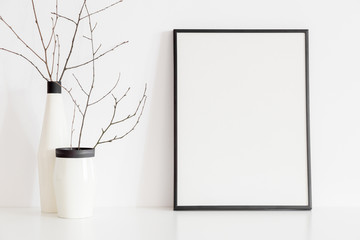  Frame and design vase with decorative twigs. Mock up