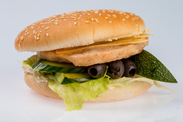 cheeseburger with beef cutlet, bacon, tomatoes and cheese slices, seasoned with sauce and green salad for a restaurant menu on a white isolated background