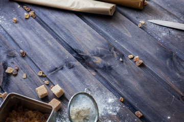 Cooking dough, cooking equipment, flour on a wooden table. Top view with copy space, mockup for menu, recipe. Baking background.