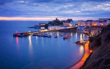 Tenby harbour, wales just before sunrise, Boats and buildings in blue hour. - obrazy, fototapety, plakaty