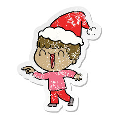 laughing distressed sticker cartoon of a man pointing wearing santa hat