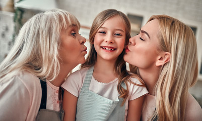 Daughter, mother and grandmother on kitchen