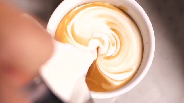 Macro Shot Of Steamed Milk Poured Into Coffee To Make Cappuccino design. Making Of Cafe Latte Art at cafe brista bar, Heart Shape Slow Motion Close Up Steamed Milk Pour Into Cappuccino