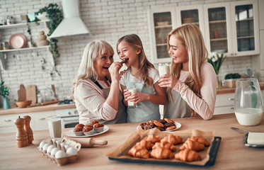 Daughter, mother and grandmother on kitchen