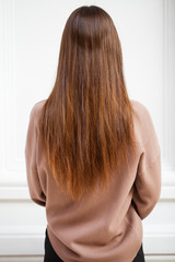 Fototapeta premium Female long wavy hair, rear view, indoor
