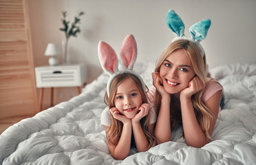 Mother with daughter on bed