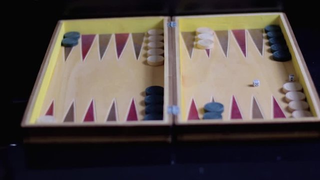 Beginning of a backgammon game with a player who throw dices on board