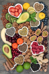 Stress and anxiety relieving food selection with herbs and spice used in herbal medicine. Health foods that help relaxation and reduce chronic fatigue and depression. Top view on marble.