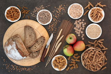 Food for a high fibre diet with apples, whole grain rye bread, whole wheat pasta, oatmeal, oats,...