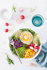 vegan avocado sweet corn lunch bowl with hummus, red cabbage, radish and sprouts