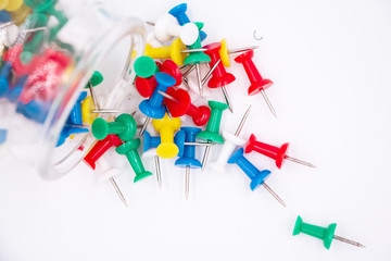 The colorful push pins put on white background,blurry light around