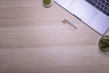 Flat lay, Top view office table desk, Workspace with marijuana buds, keyboard, and office supplies