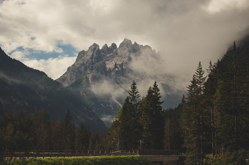 Amazing glacier made valley in the Italian Dolomites with trees in the summer ready for a hike or active holiday 