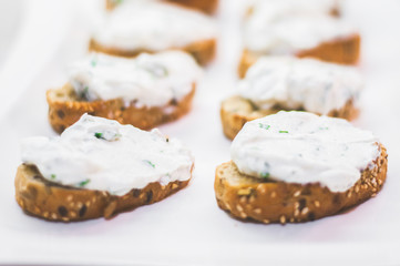 Cream cheese with herbs on a white bread