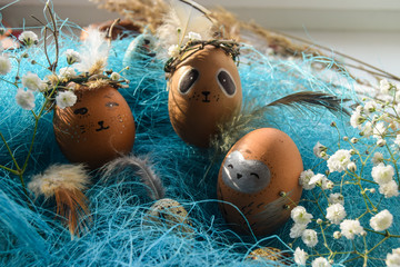 Easter holiday concept with cute handmade eggs, rabbit, chicks, owl, panda and deer. Creative eggs...