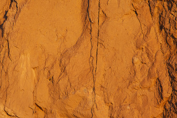 bright orange surface of the soil with sand, background, texture