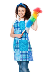 Happy young housewife holding duster - isolated on white background