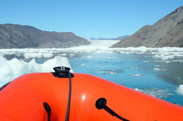Sailing on an inflatable boat among the icebergs, Greenland