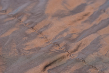 brown satine textile background texture selective focus