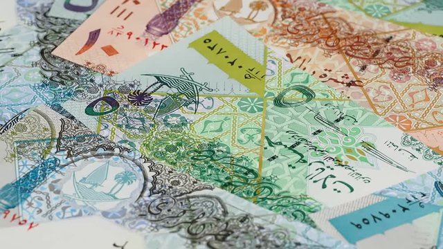 Qatar currency riyal notes slow rotating. Qatari money. Low angle. Stock video footage.