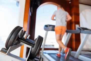 a man of age is engaged in running on a treadmill