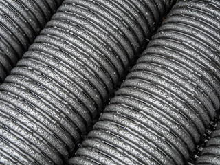 Black plastic pipes of various diameters in a row