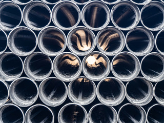 Black plastic pipes of various diameters in a row