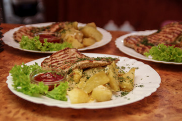 Fried meat and potato with a sauce on a dish 