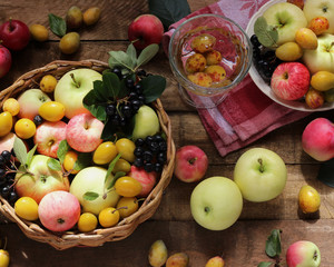 Village garden berries and fruits: apples, plums, chokeberry in the basket.