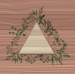 triangular frame with laurel leafs wooden background